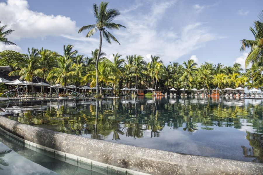 Swimming pool with palm trees behind at Trou aux Biches Beachcomber Golf Resort & Spa