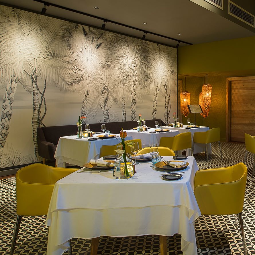 Yellow chairs in dining area at Anahita Golf And Spa Resort