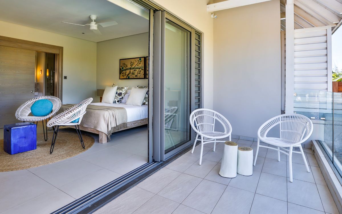 Balcony area with two chairs and a table at Anahita Golf And Spa Resort