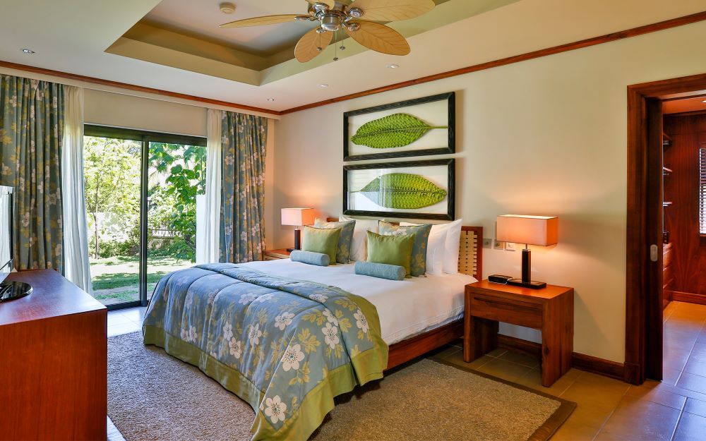 Luxury bedroom with wooden furniture at Anahita Golf And Spa Resort