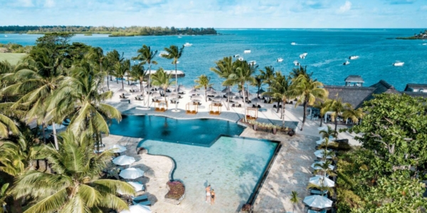 Swimming pool surrounded by palm trees at Anahita Golf And Spa Resort