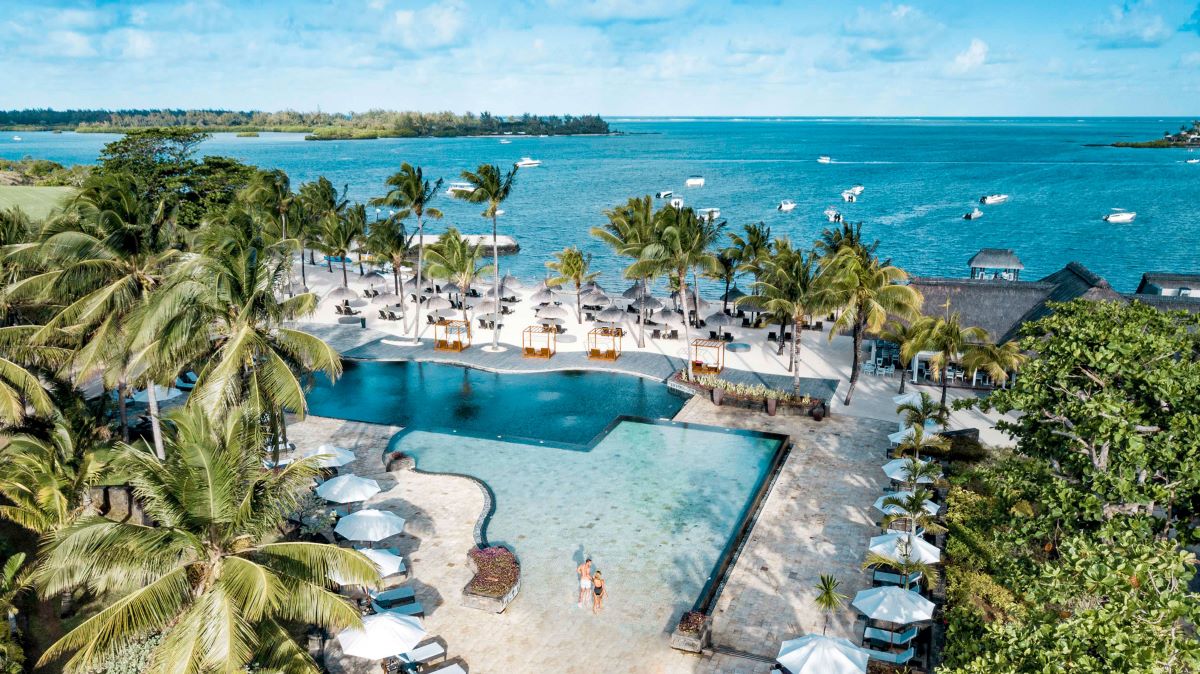 Swimming pool surrounded by palm trees at Anahita Golf And Spa Resort