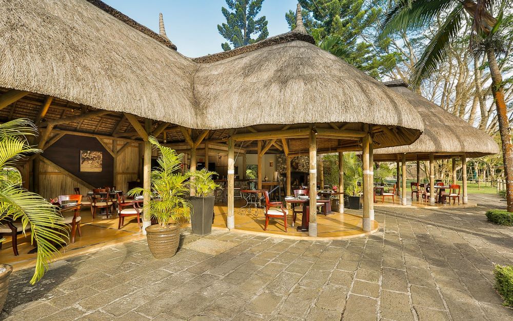 Wooden hut with thatched roof at Anahita Golf And Spa Resort