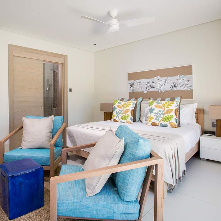 Bedroom with blue chairs at Anahita Golf And Spa Resort