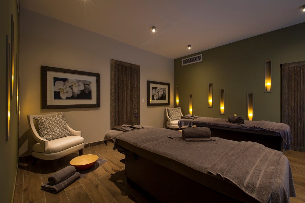 Spa treatment room with towels on treatment tables at Anahita Golf And Spa Resort