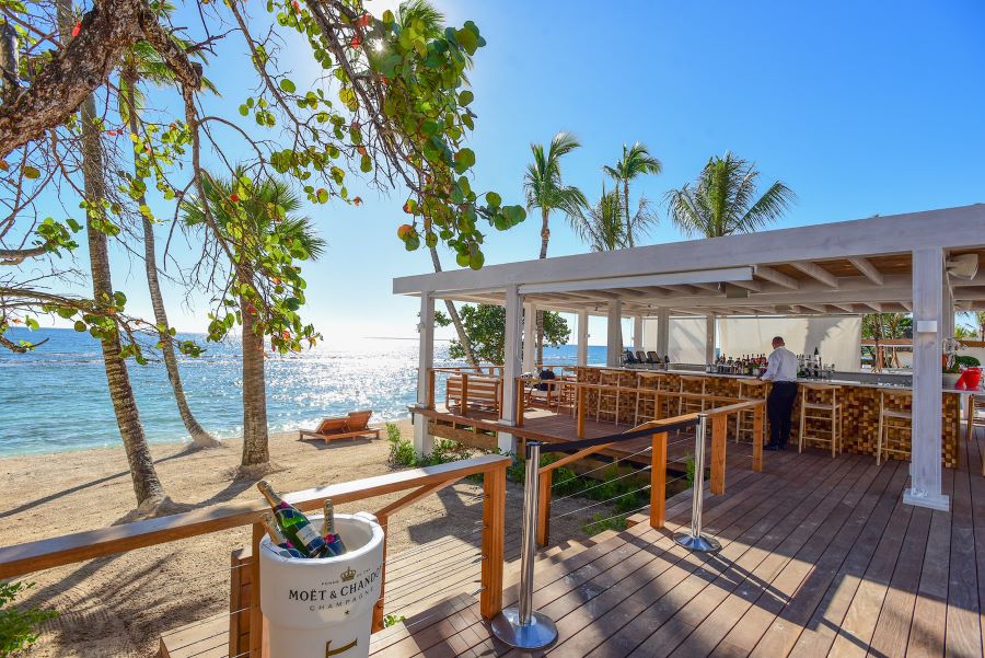 Beach bar and palm trees at Casa de Campo Resort & Villas in Dominican Republic