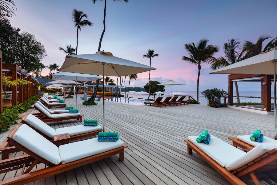 Sun loungers with towels on decking at Casa de Campo Resort & Villas