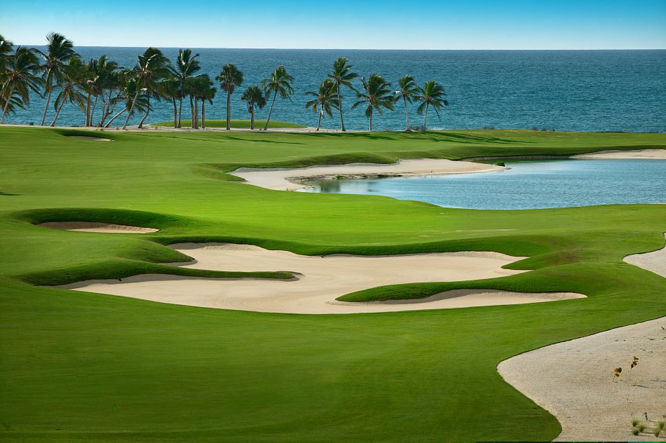 Trees lining the fairway in the distance, with the Caribbean sea beyond at Punta Espada