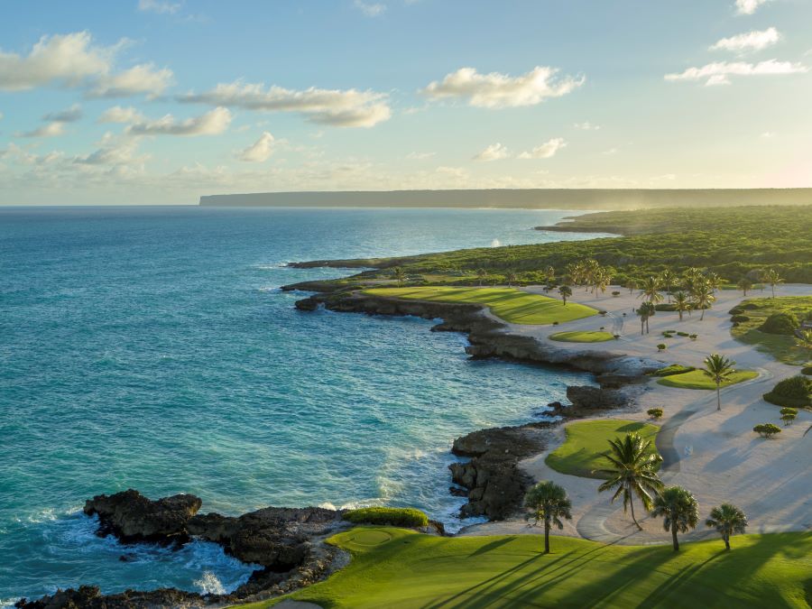 Clear blue water with waves lapping up to the edge of the course at Punta Espada Golf Club