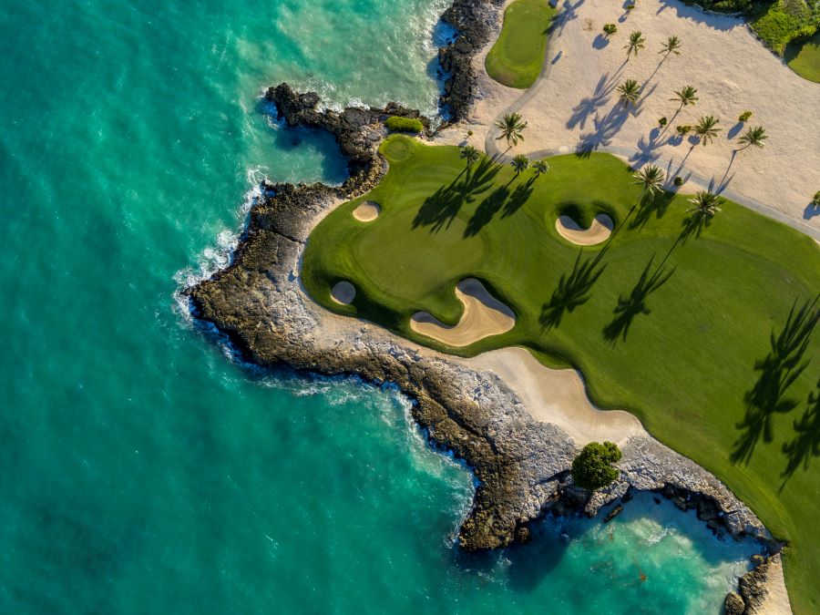 Drone shot of the putting green at Punta Espada Golf Club, surrounded by turquoise water