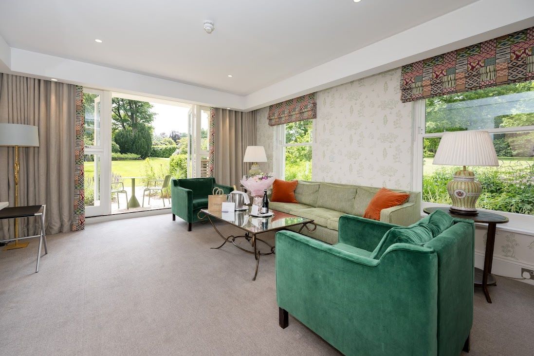 Living area with green chairs at Rudding Park