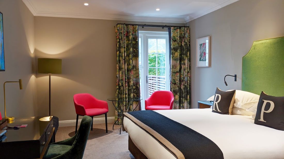 Bedroom with two pink chairs at Rudding Park in Harrogate, Yorkshire