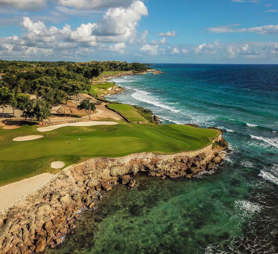 Green perched by the sea, protected by rocks and stone at Teeth of the Dog golf course