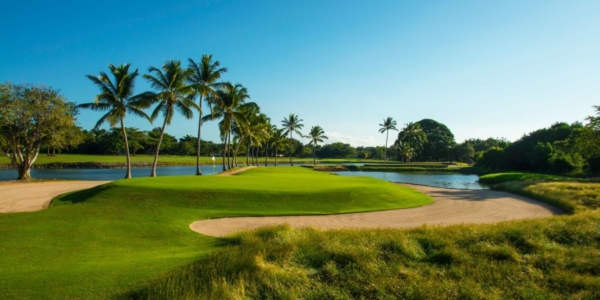 The Links Golf Course in Dominican Republic with large sand bunker surrounding the putting green