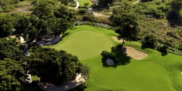 Shot of Iberostar Bavaro Golf Club from the air featuring putting green surrounded by trees