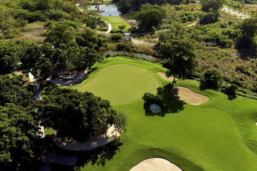 Shot of Iberostar Bavaro Golf Club from the air featuring putting green surrounded by trees