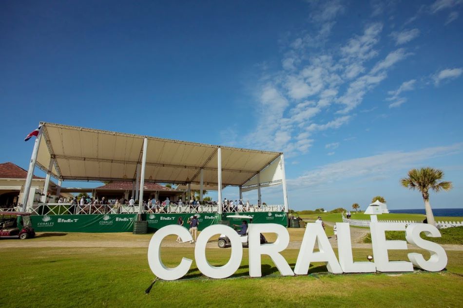 Large white letter sign spelling out Corales on the golf course