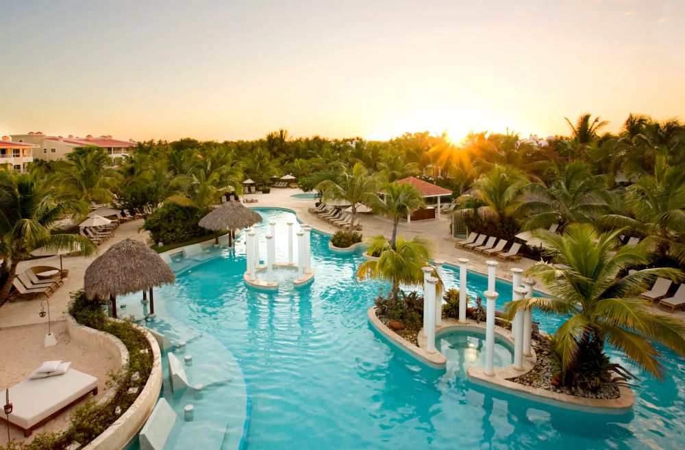 Swimming pool with pillars and sun loungers at Melia Caribe Beach Resort