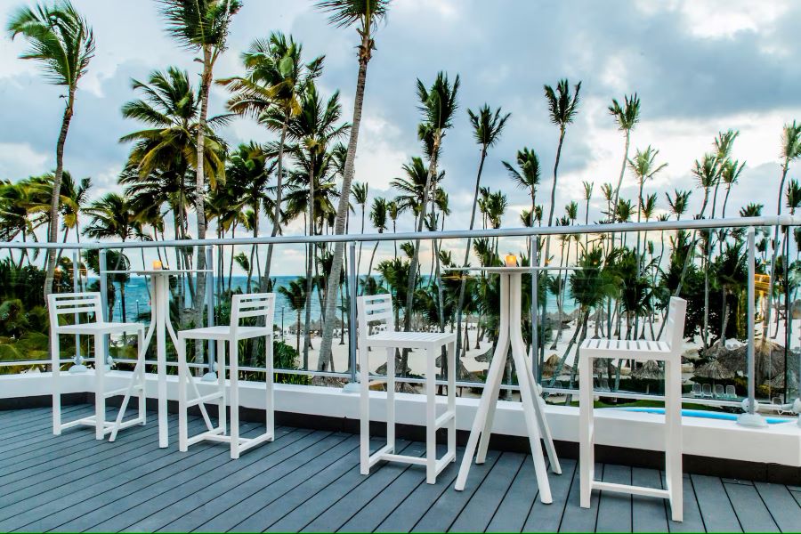 White stools at bar overlooking the beach at Melia Punta Cana Beach Resort