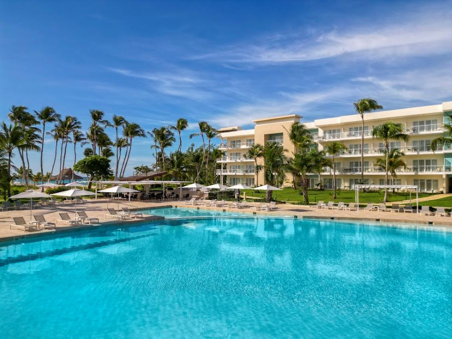 Swimming pool with palm trees in the distance at The Westin Puntacana Resort & Club