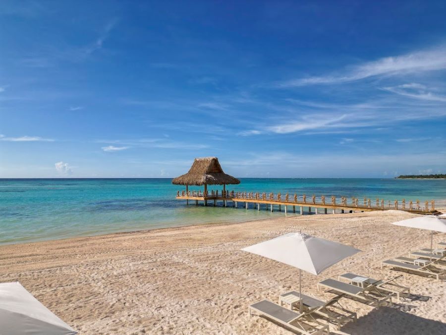 View of the jetty from the beach with sun loungers in the foreground at The Westin Puntacana Resort & Club