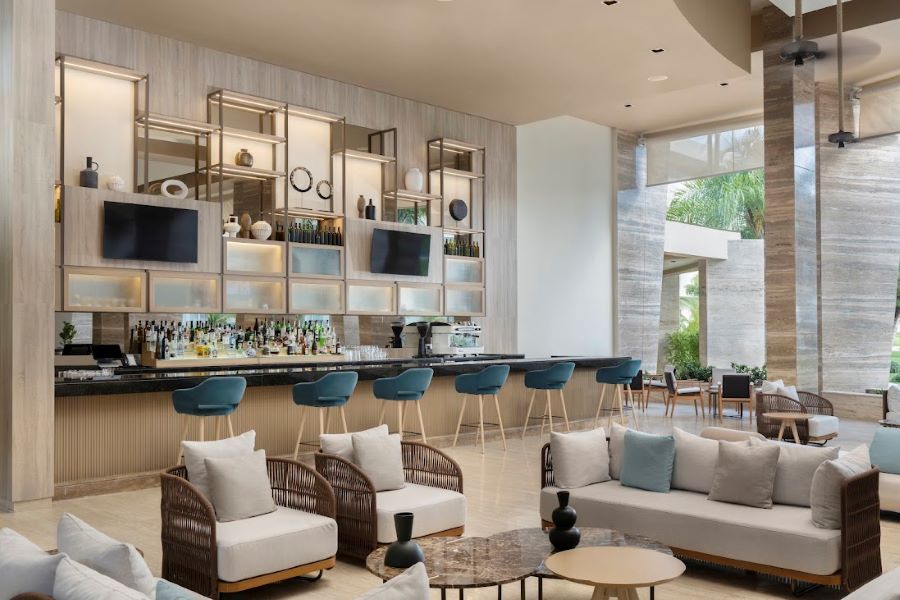 Green stools at the bar with grey chairs in front at The Westin Puntacana Resort & Club