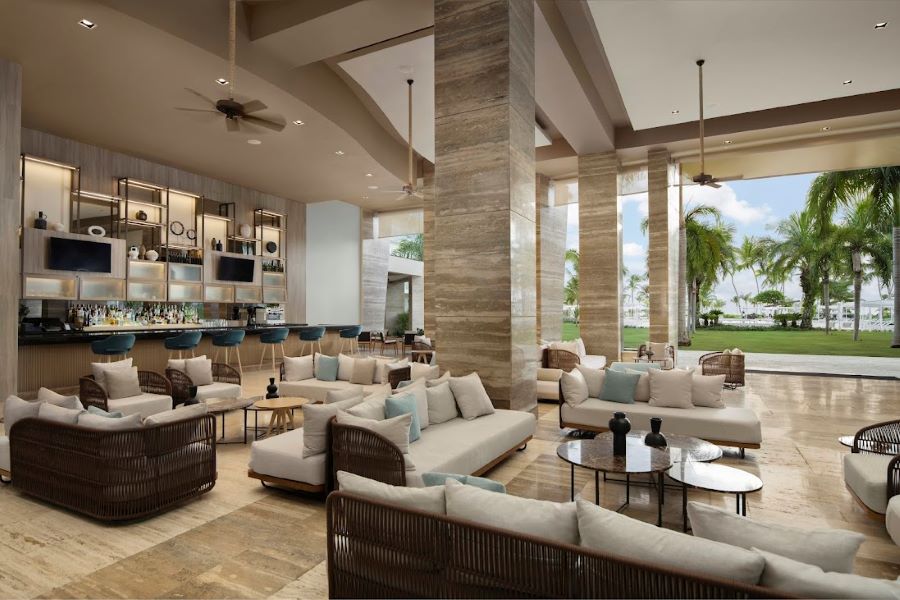 Seating area with grey sofas and chairs in lobby area at The Westin Puntacana Resort & Club