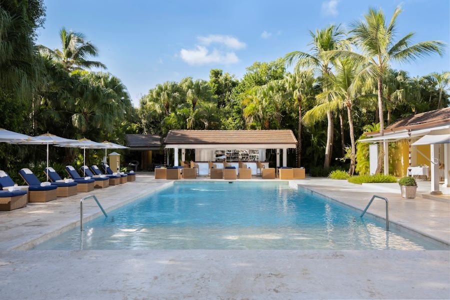 Swimming pool surrounded by sun loungers at Tortuga Bay Hotel at Puntacana Resort & Club